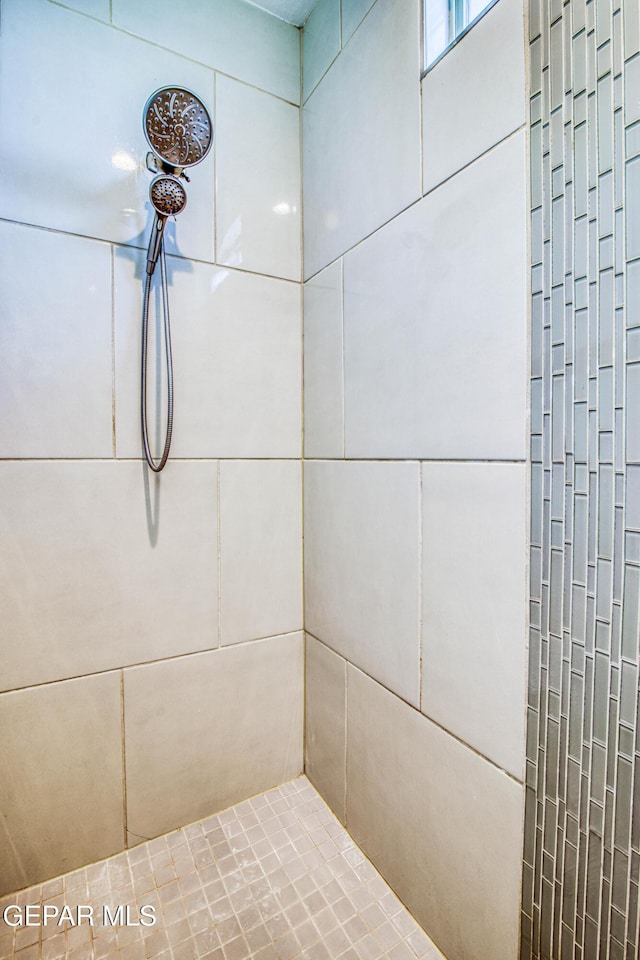 bathroom with tiled shower