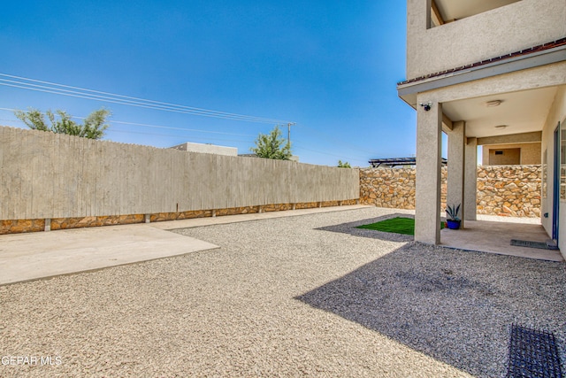 view of yard with a fenced backyard and a patio
