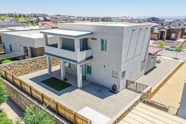 back of property with a patio, a fenced backyard, and a residential view