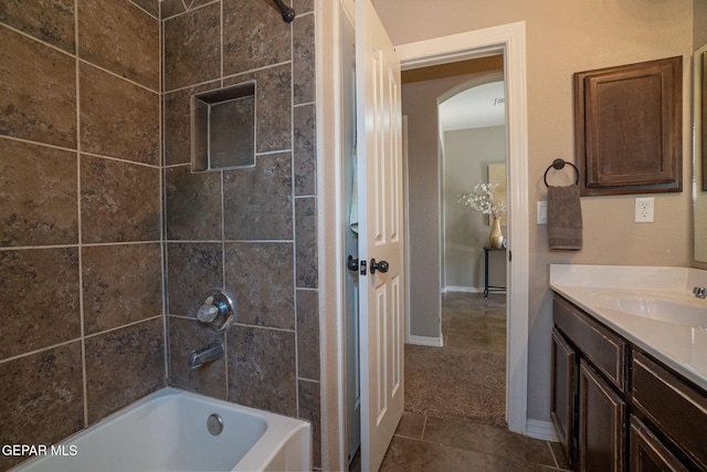 bathroom with  shower combination, baseboards, tile patterned flooring, and vanity