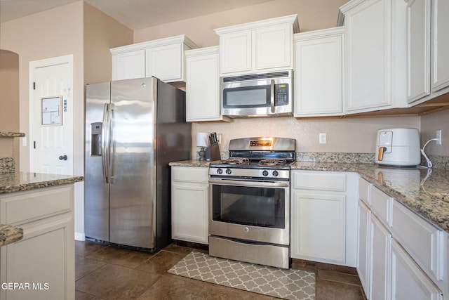 kitchen featuring white cabinetry, light stone countertops, and appliances with stainless steel finishes