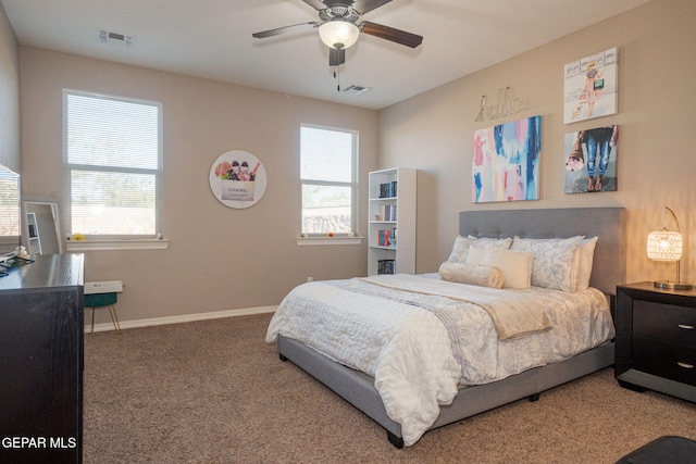 carpeted bedroom featuring visible vents, baseboards, and ceiling fan