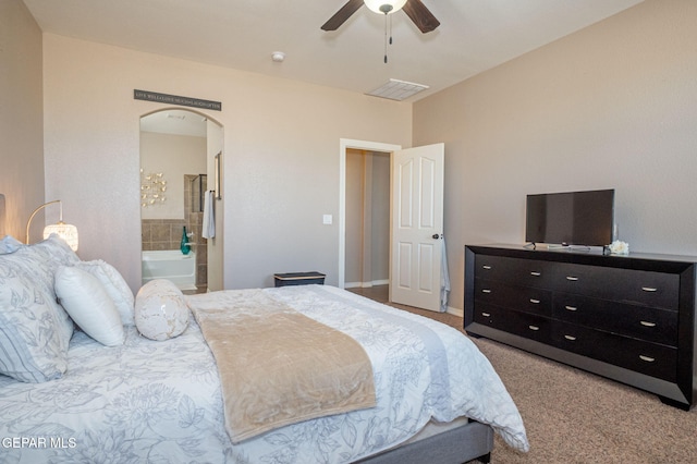 carpeted bedroom with arched walkways, a ceiling fan, connected bathroom, and visible vents