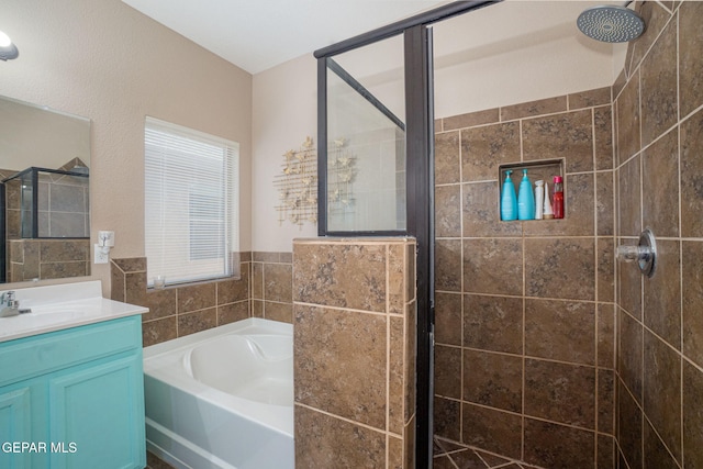 bathroom with vanity, a bath, and a stall shower