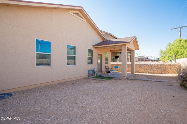 back of property featuring a patio area, stucco siding, and fence