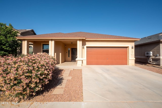 view of front of property featuring an attached garage, stucco siding, and concrete driveway
