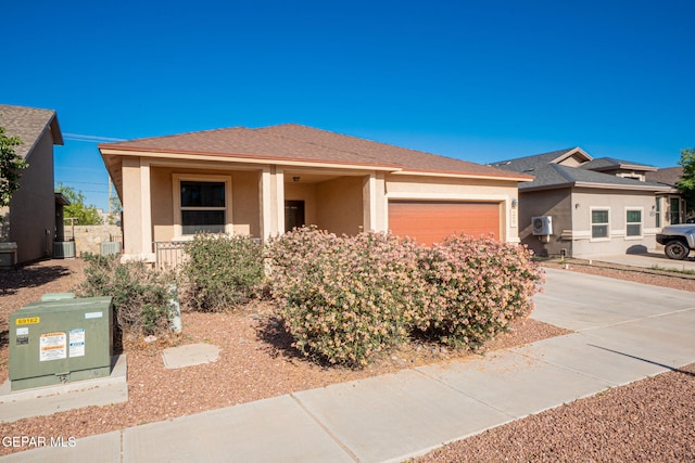 view of front facade featuring central air condition unit, a garage, stucco siding, and driveway