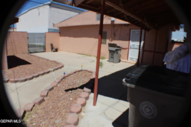 view of patio / terrace featuring fence and a gate