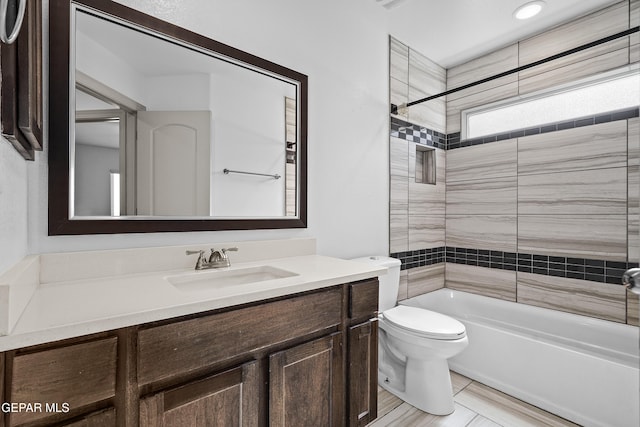 bathroom featuring shower / bathtub combination, toilet, and vanity