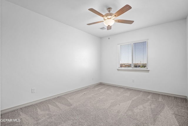 carpeted empty room featuring visible vents, baseboards, and ceiling fan