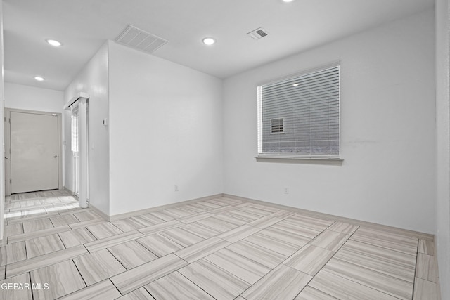 tiled spare room with visible vents and recessed lighting