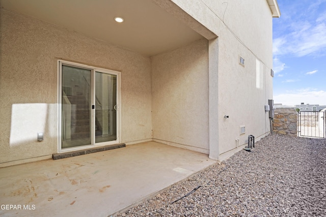 exterior space with a patio area and stucco siding