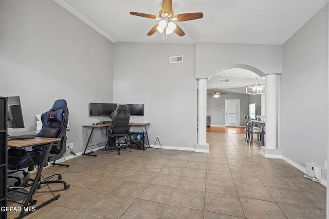 office space featuring visible vents, decorative columns, arched walkways, tile patterned floors, and a ceiling fan