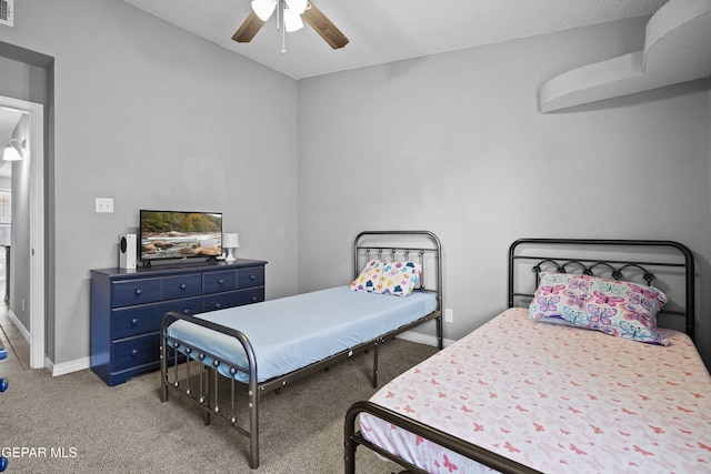 bedroom featuring baseboards, light carpet, a ceiling fan, and visible vents