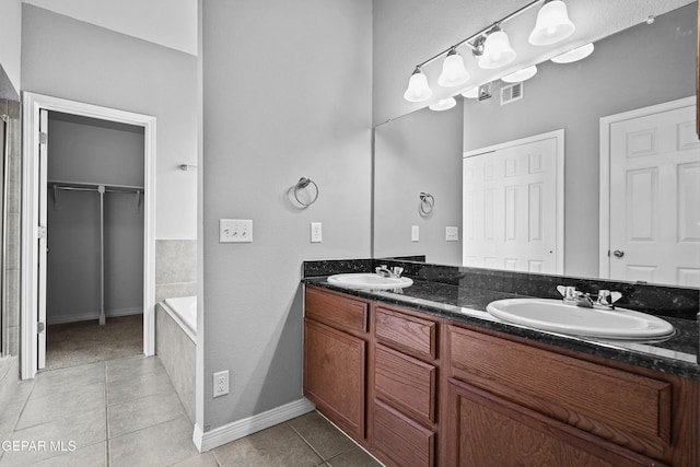 bathroom with tile patterned floors, visible vents, and a sink