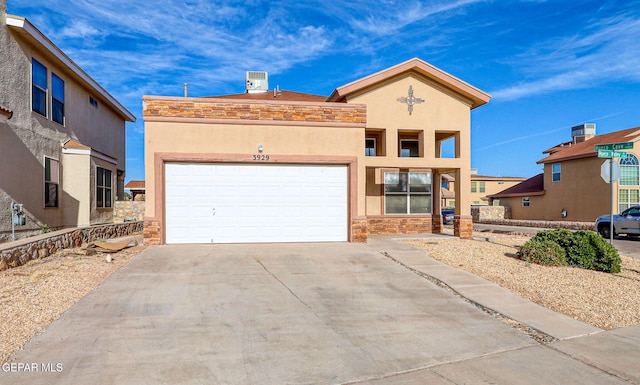3929 Hueco Valley Dr, El Paso, TX 79938 - mediterranean / spanish house with a garage, stucco siding, concrete driveway, and stone siding