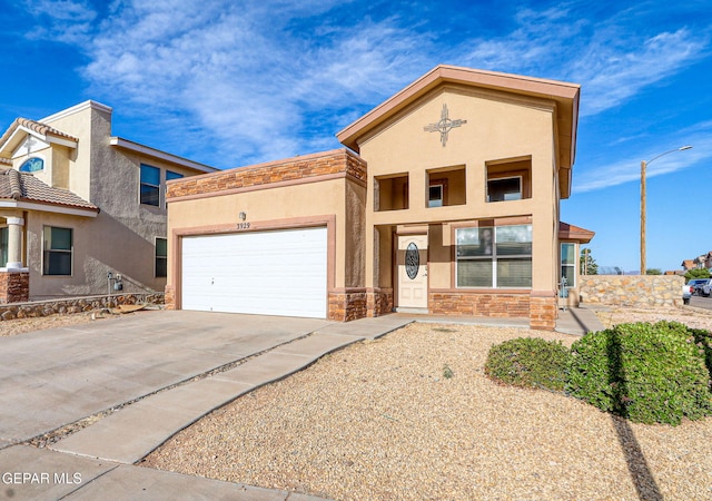 3929 Hueco Valley Dr, El Paso, TX 79938 - view of front of house with concrete driveway, an attached garage, stone siding, and stucco siding