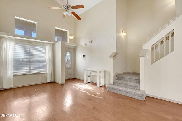 3929 Hueco Valley Dr, El Paso, TX 79938 - entryway with ceiling fan, high vaulted ceiling, baseboards, wood finished floors, and stairway