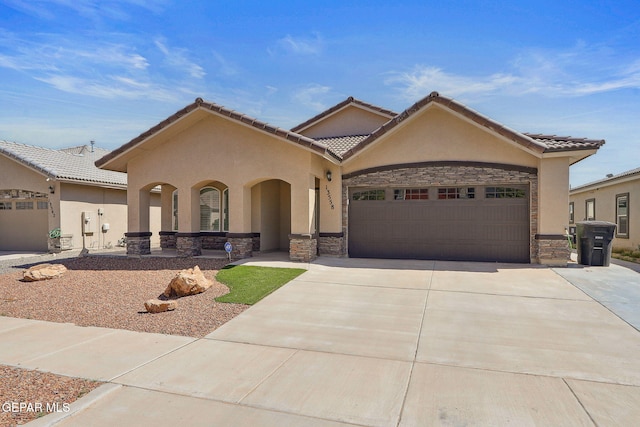 view of front of property with an attached garage, concrete driveway, stucco siding, and stone siding