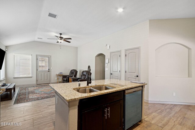 kitchen featuring visible vents, ceiling fan, arched walkways, a sink, and dishwasher