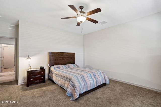 carpeted bedroom with a ceiling fan, baseboards, and visible vents