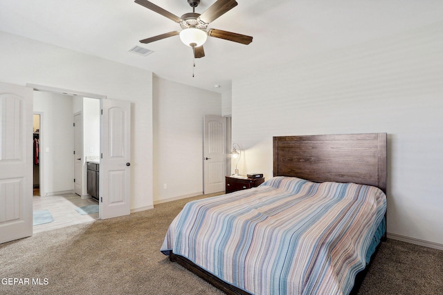 bedroom featuring baseboards, ceiling fan, light colored carpet, and visible vents