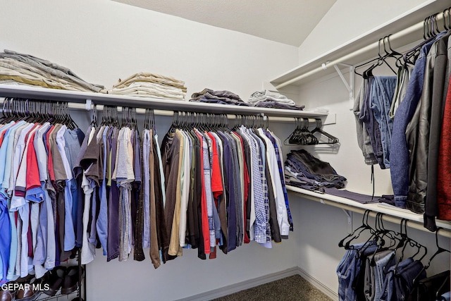 spacious closet with carpet and vaulted ceiling