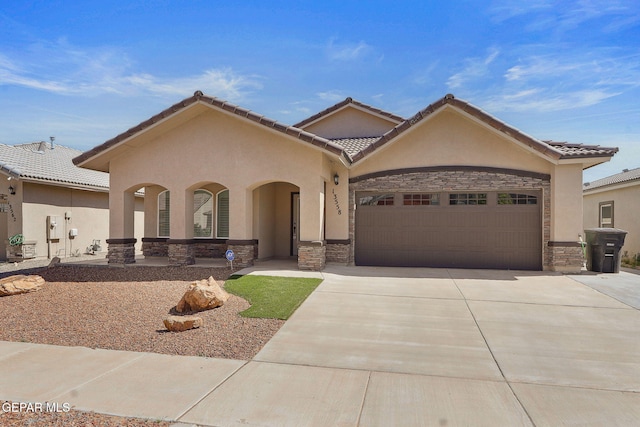 view of front facade with an attached garage, stucco siding, stone siding, and concrete driveway