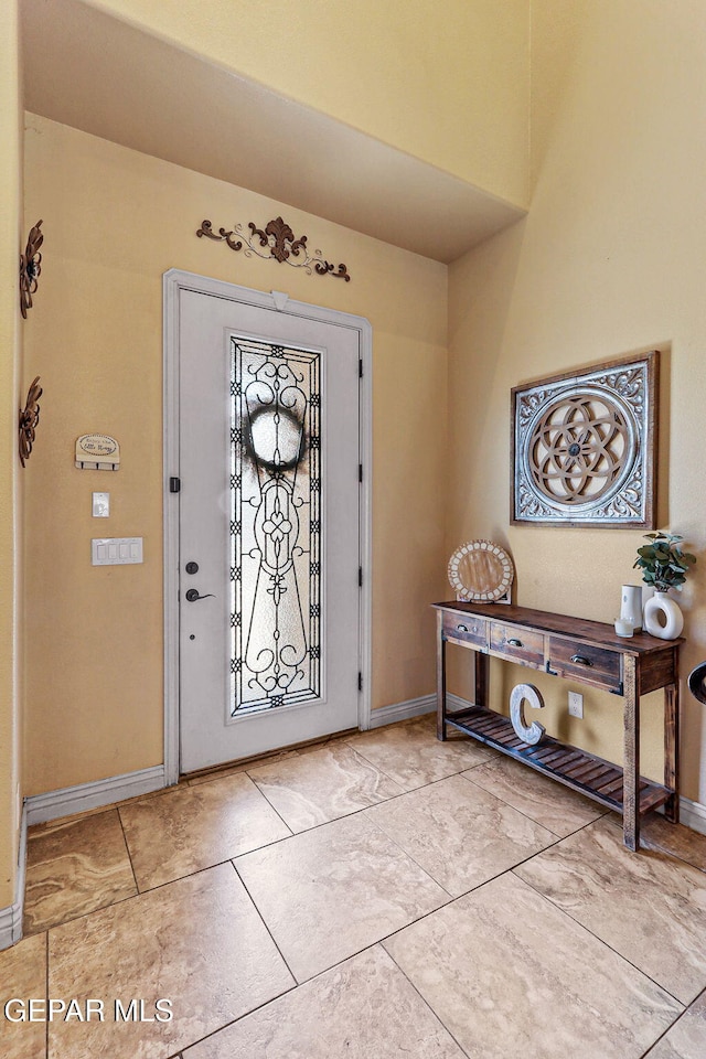 foyer featuring baseboards