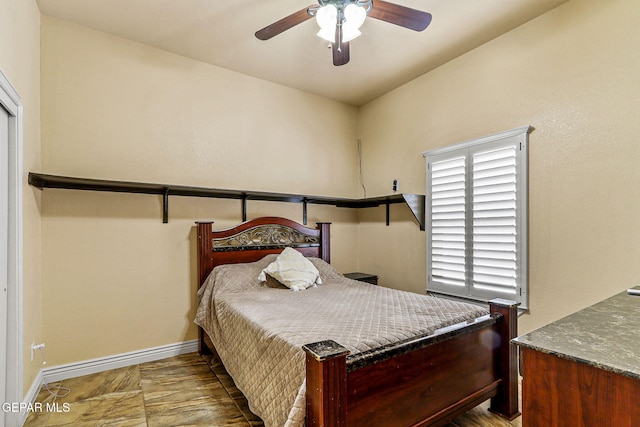bedroom featuring baseboards and ceiling fan