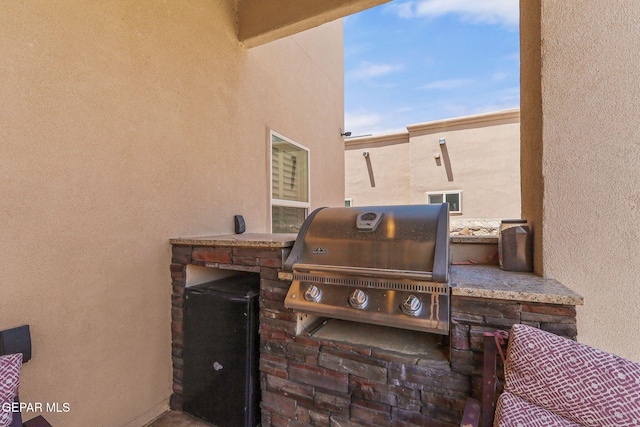view of patio featuring area for grilling and a grill