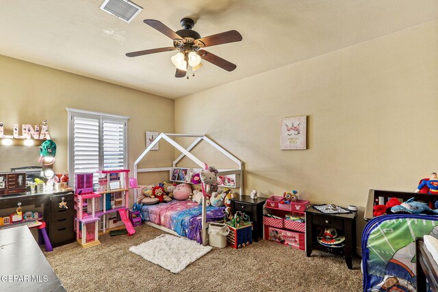 carpeted bedroom with visible vents and a ceiling fan