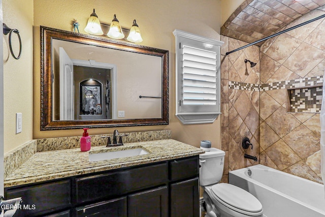 bathroom with bathtub / shower combination, toilet, and vanity