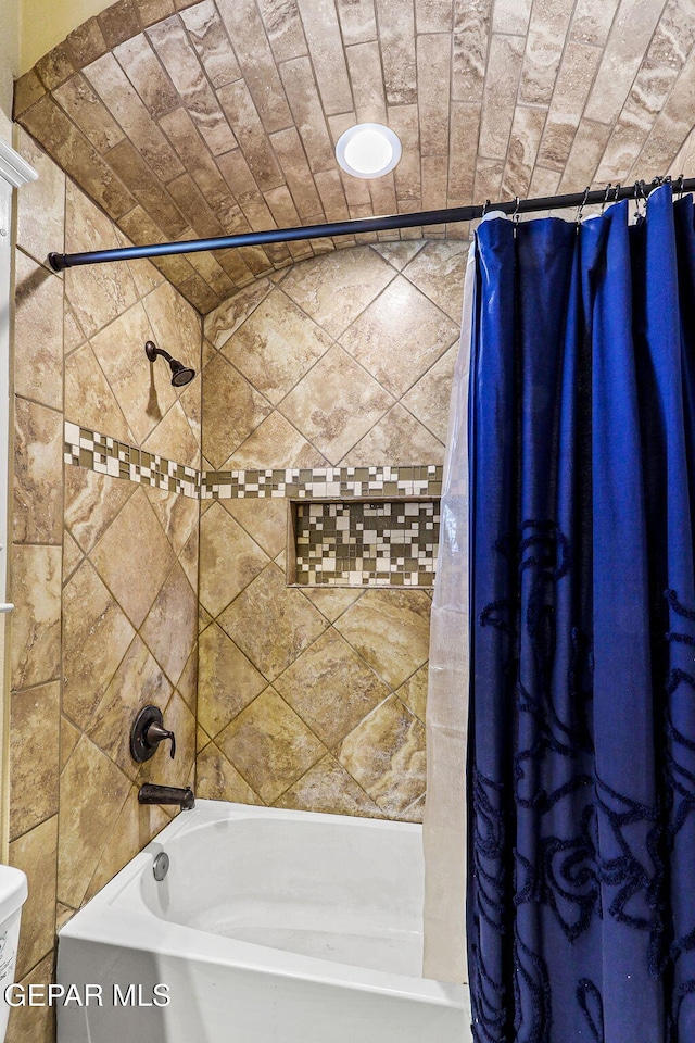 bathroom with shower / tub combo with curtain