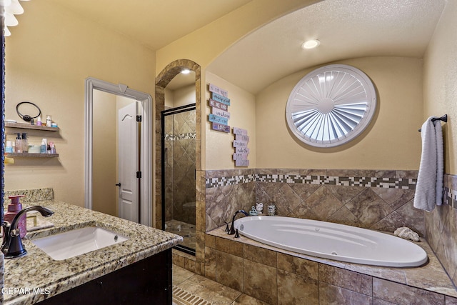 full bathroom featuring a shower stall, tile patterned flooring, a garden tub, and vanity