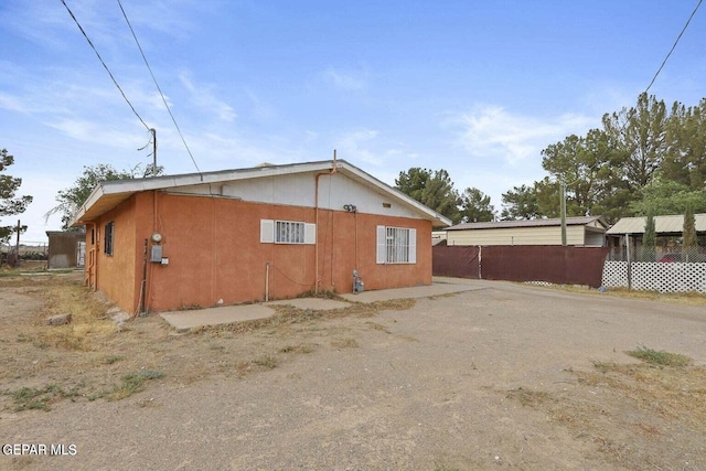 12365 Stubbs Dr, San Elizario, TX 79849 - view of side of home with fence and stucco siding