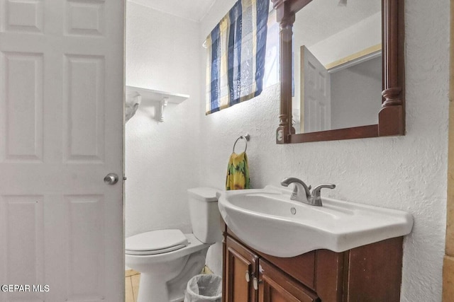 12365 Stubbs Dr, San Elizario, TX 79849 - bathroom featuring vanity, a textured wall, and toilet