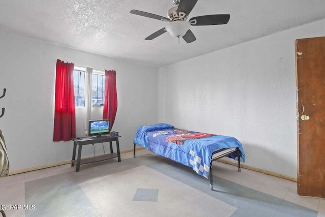 12365 Stubbs Dr, San Elizario, TX 79849 - bedroom with a textured ceiling, baseboards, and ceiling fan
