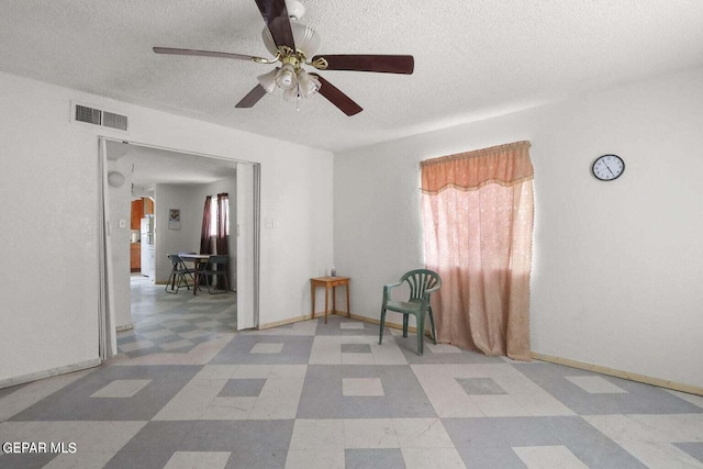 12365 Stubbs Dr, San Elizario, TX 79849 - interior space with a ceiling fan, a textured ceiling, visible vents, and a healthy amount of sunlight
