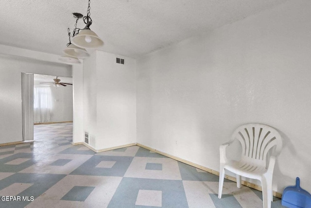 12365 Stubbs Dr, San Elizario, TX 79849 - spare room with a ceiling fan, a textured ceiling, visible vents, tile patterned floors, and baseboards