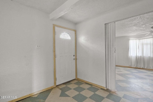 12365 Stubbs Dr, San Elizario, TX 79849 - foyer featuring baseboards, a ceiling fan, a textured ceiling, and tile patterned floors
