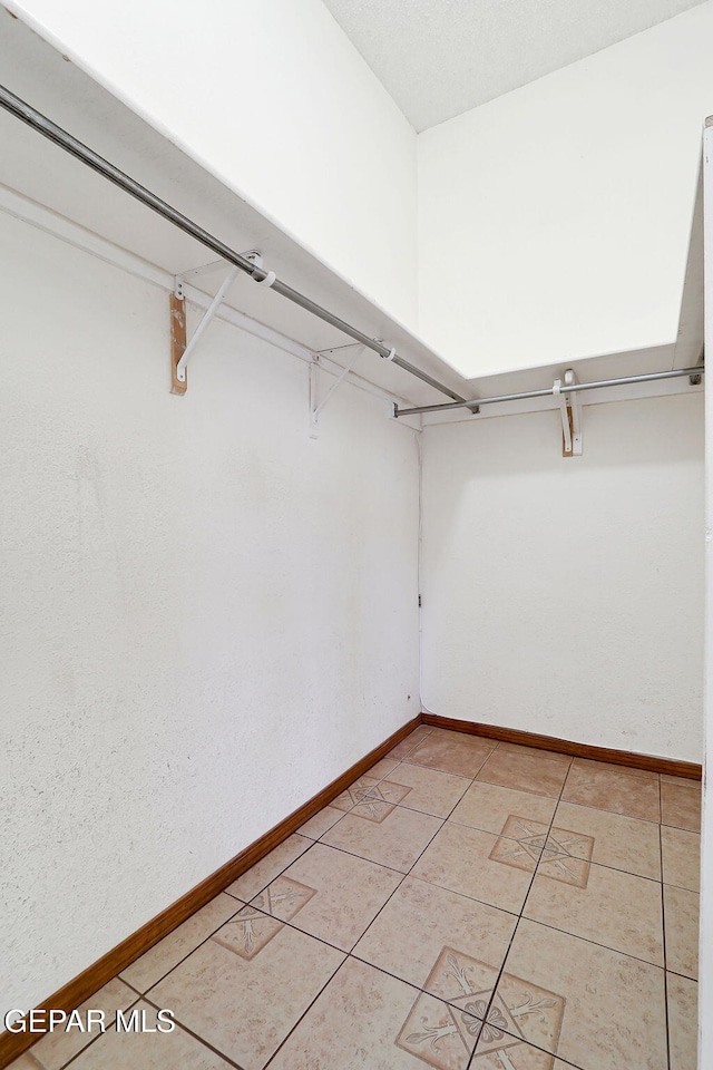 spacious closet featuring light tile patterned floors