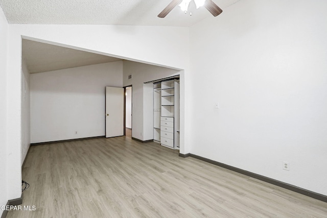 interior space with visible vents, baseboards, high vaulted ceiling, a ceiling fan, and light wood-style flooring