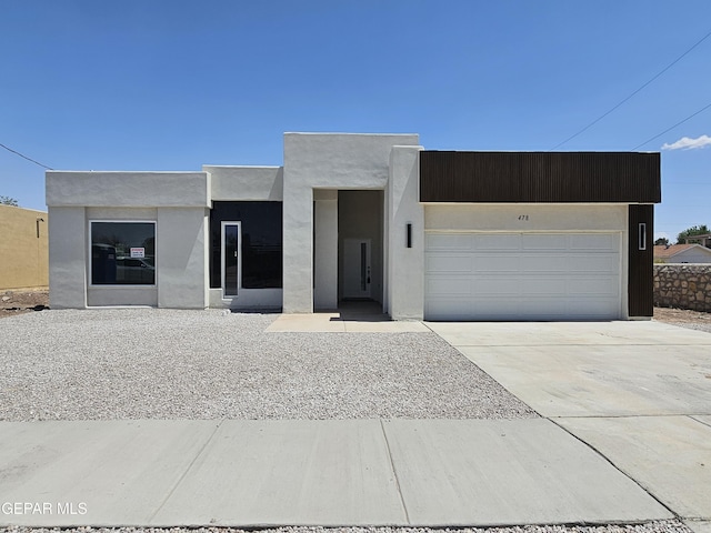 478 Sylvia Ct, Socorro, TX 79927 - view of front of house featuring a garage, driveway, and stucco siding