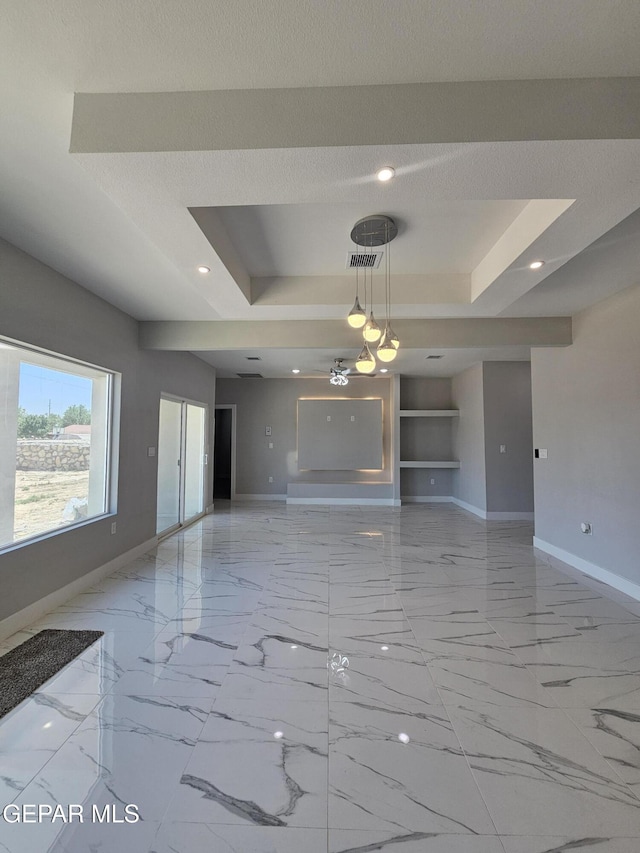 478 Sylvia Ct, Socorro, TX 79927 - unfurnished living room with a tray ceiling, light marble finish flooring, built in shelves, and recessed lighting