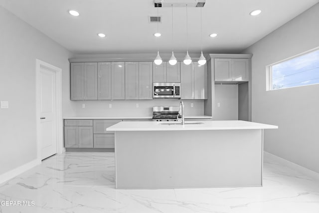 478 Sylvia Ct, Socorro, TX 79927 - kitchen featuring stainless steel appliances, gray cabinets, light marble finish flooring, light countertops, and recessed lighting