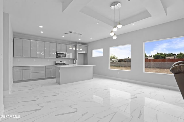 478 Sylvia Ct, Socorro, TX 79927 - kitchen featuring range, open floor plan, stainless steel microwave, gray cabinetry, and recessed lighting