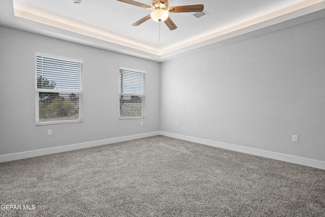 478 Sylvia Ct, Socorro, TX 79927 - spare room with a raised ceiling, a ceiling fan, and carpet flooring