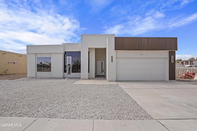 478 Sylvia Ct, Socorro, TX 79927 - contemporary home with a garage, concrete driveway, and stucco siding