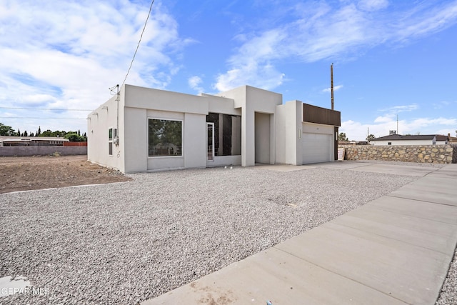 478 Sylvia Ct, Socorro, TX 79927 - contemporary home with an attached garage, stucco siding, and driveway